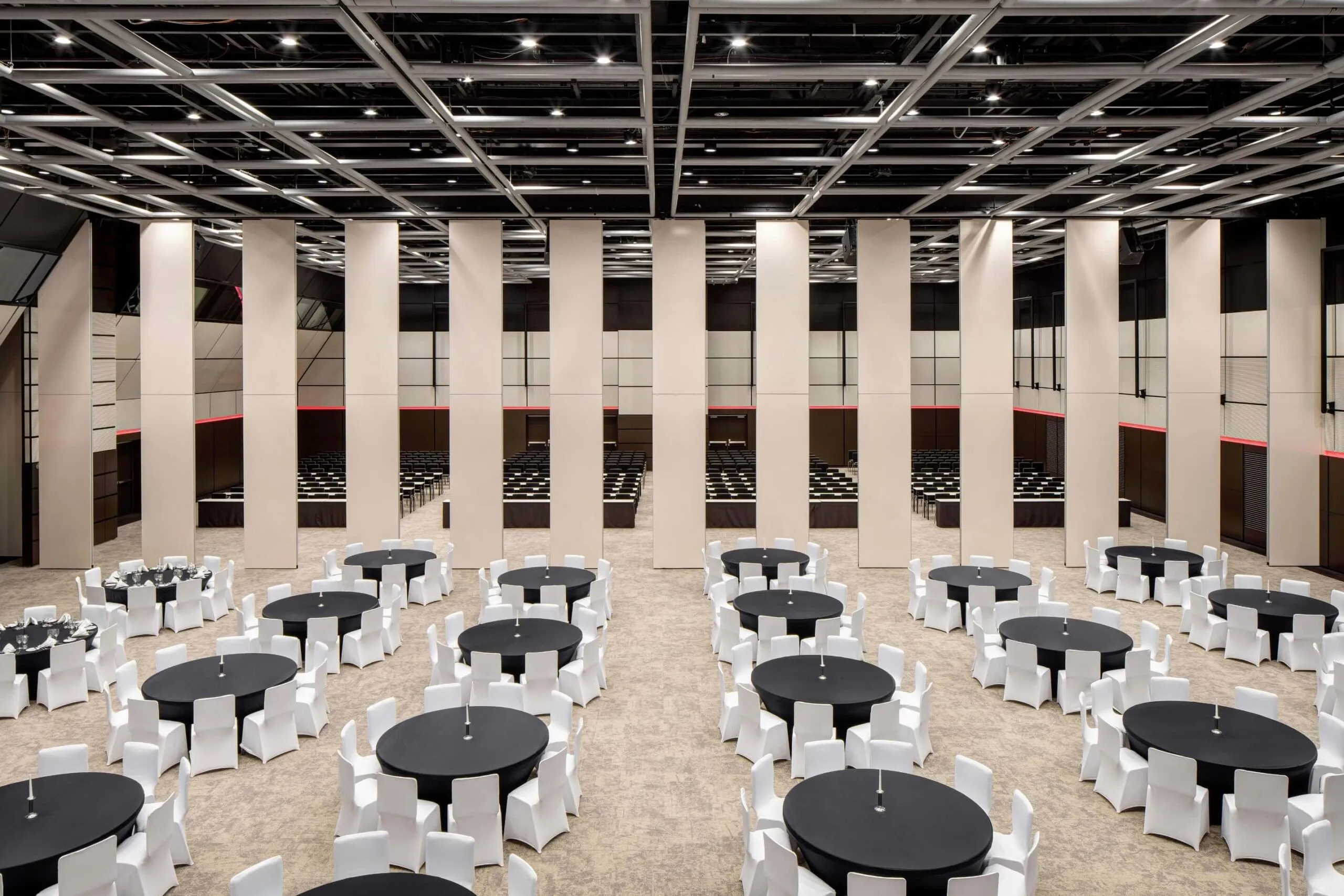 The Clarion main hall split by movable partitions: round tables in front, rows of seats behind