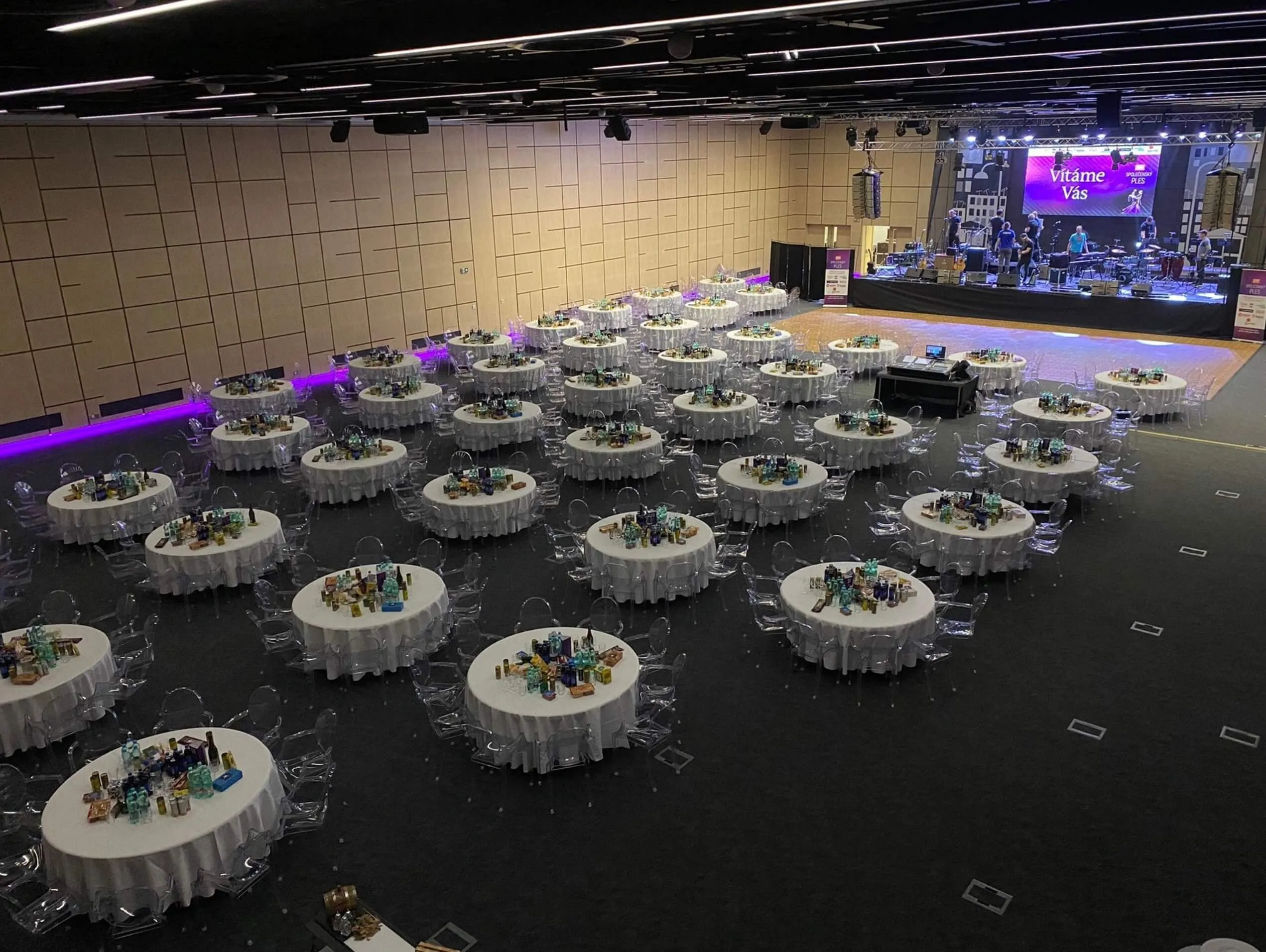 The O2 universum hall set for a ball: round tables, a dance floor and a band on stage